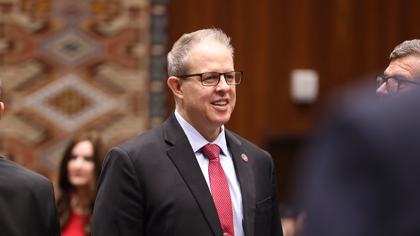 mark stewart in a suit with a red tie