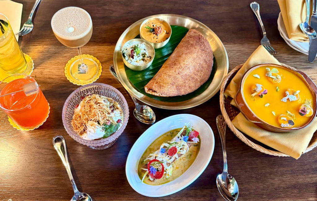 An overhead view of a table full of food and drinks from Nadu.