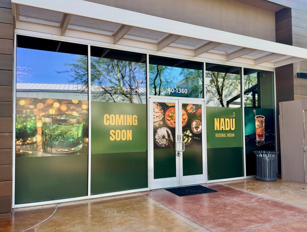 The windows outside Nadu advertise the Indian restaurant coming soon to Desert Ridge.