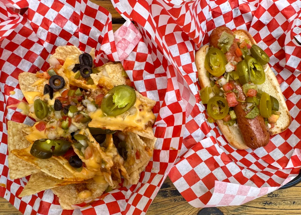 A basket of nachos and a hot dog from Pinky's.
