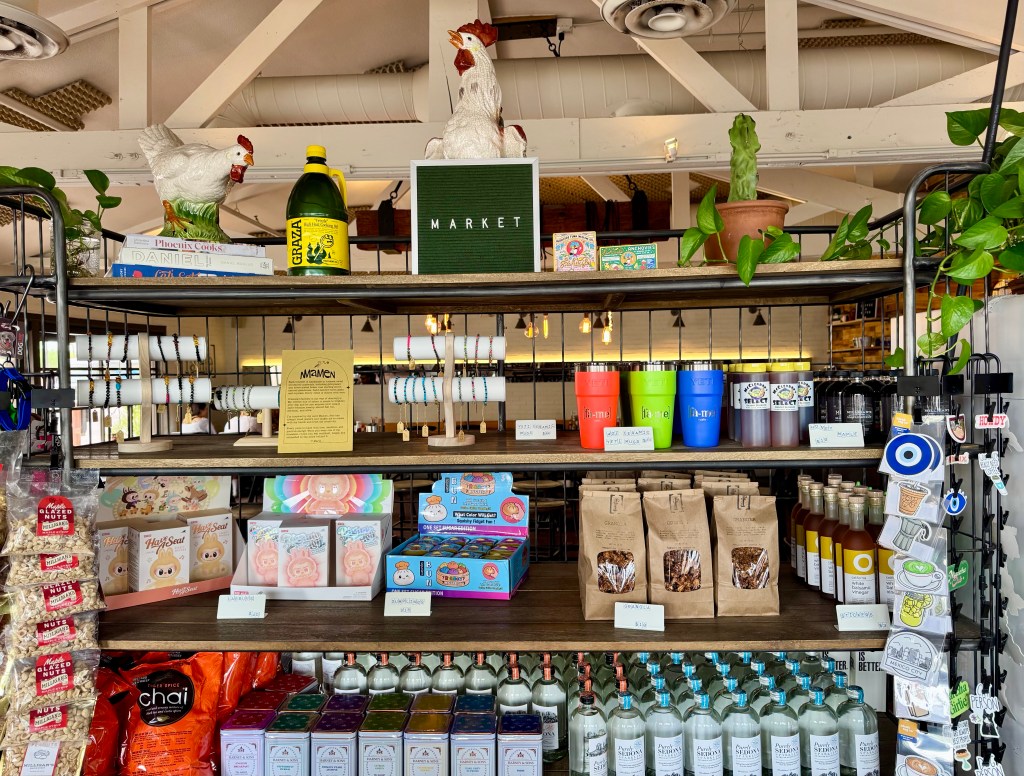 A bookshelf at Fà-me Cafe features local products and trinkets.