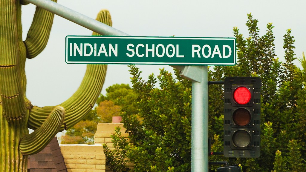 a sign for indian school road in phoenix