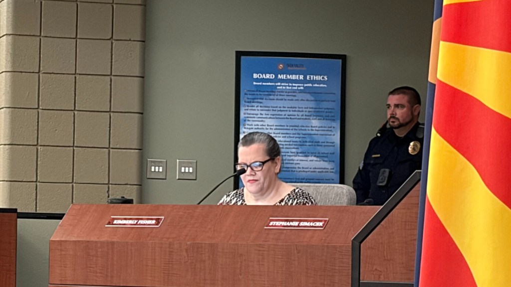 deer valley school board member kim fisher sits on a dais