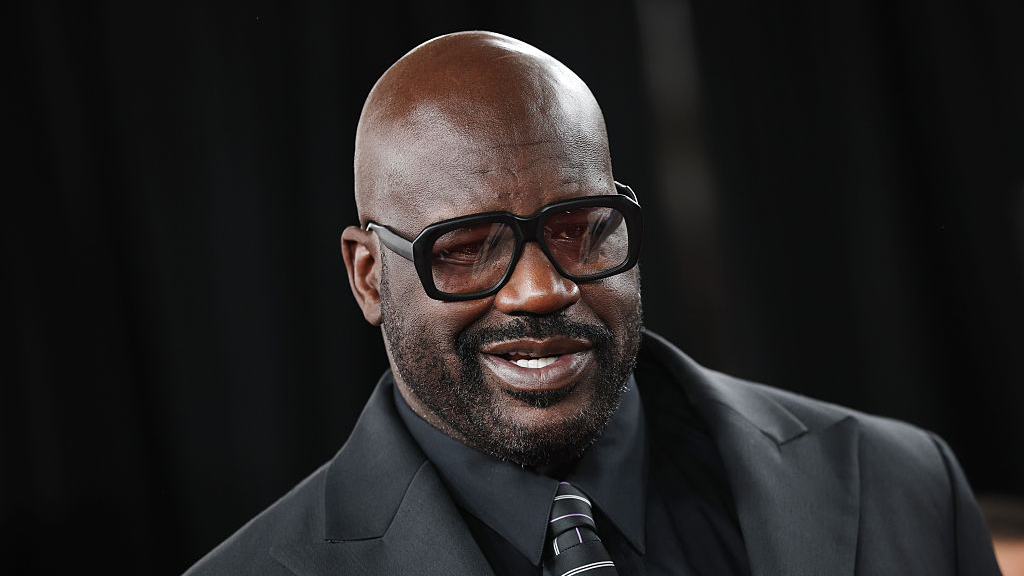 shaquille o'neal in a black suit and black glasses