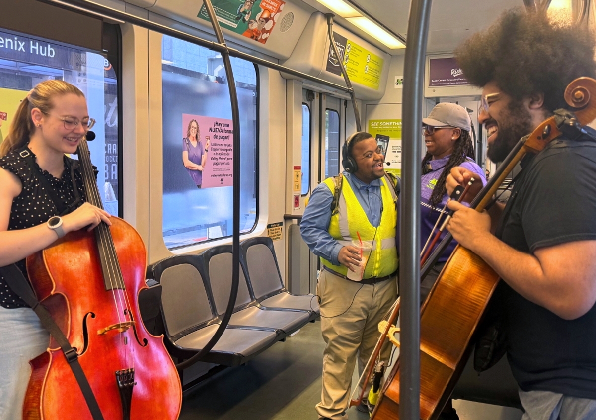 Cellists perform for Valley Metro passengers aboard a light rail train during Make Music Phoenix, a citywide celebration of music and community.