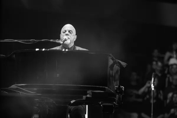 Billy Joel sings and plays piano.