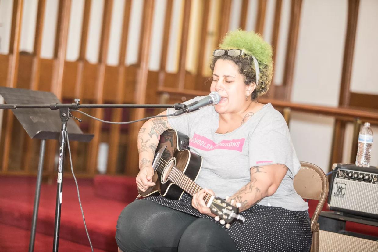 Folk icon Kimya Dawson performs with her guitar in a Phoenix church in 2017.