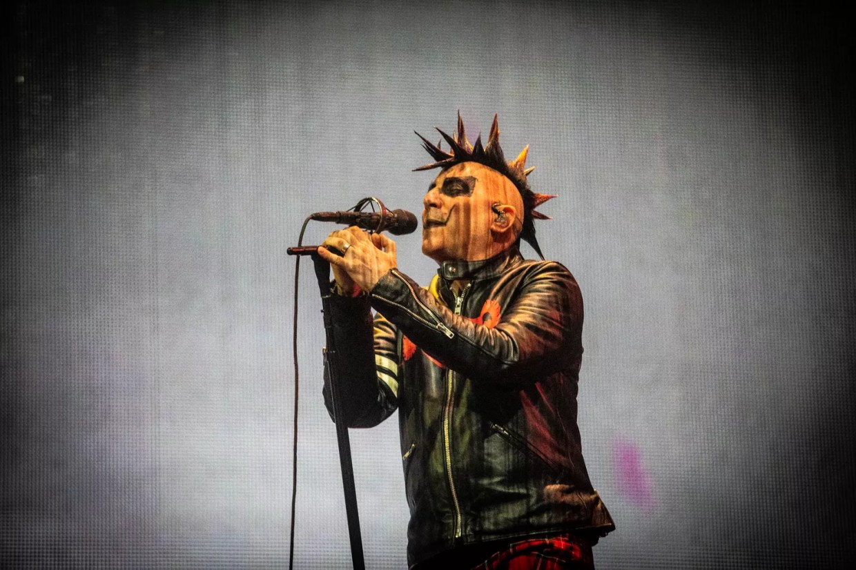 A man in makeup singing.