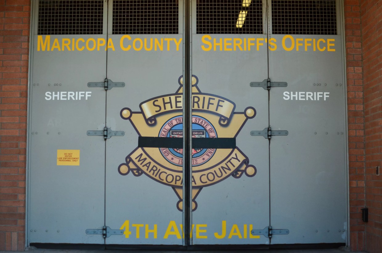 a door at the 4th avenue jail with the maricopa county sheriff's office seal on it