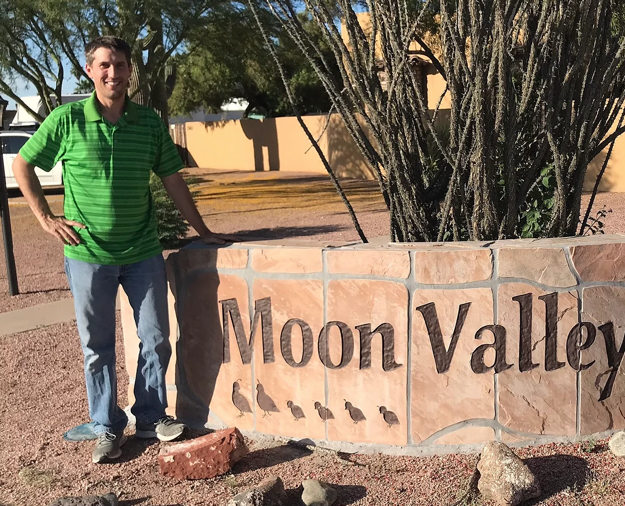 michael irish in front of a sign for moon valley