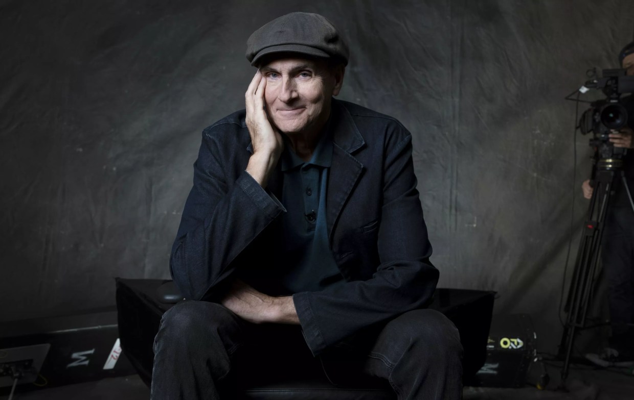 A older man posing for a photo in a hat.