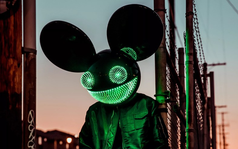 A man wearing an illuminated mouse mask.