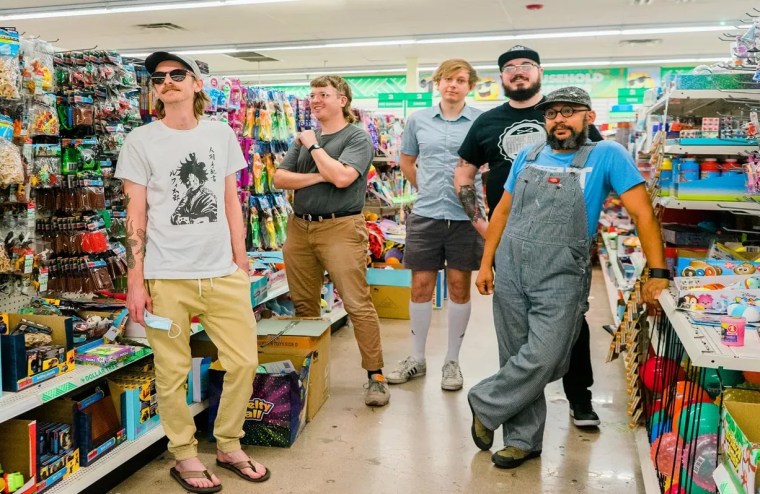 Members of band Playboy Manbaby inside a store