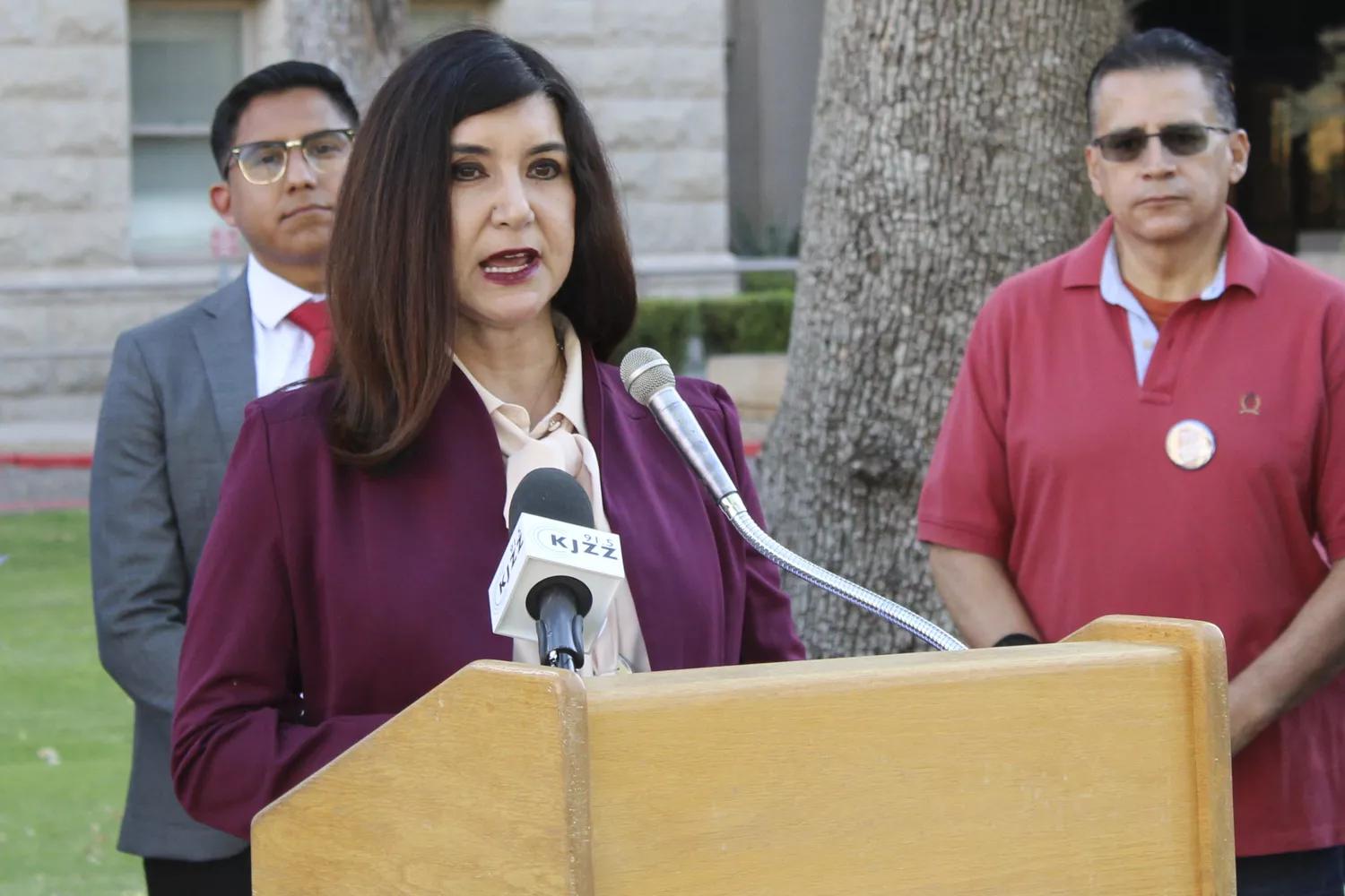 State Sen. Eva Diaz speaking at a podium.