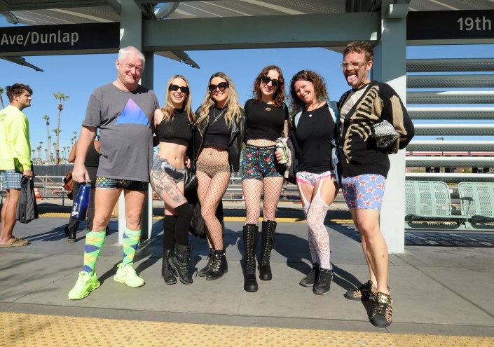People wearing no pants at a light rail station.