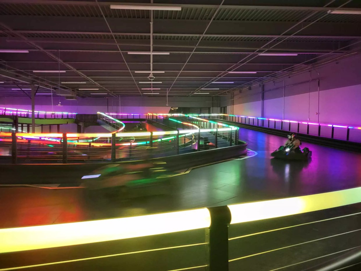 An indoor lighted go-kart track.