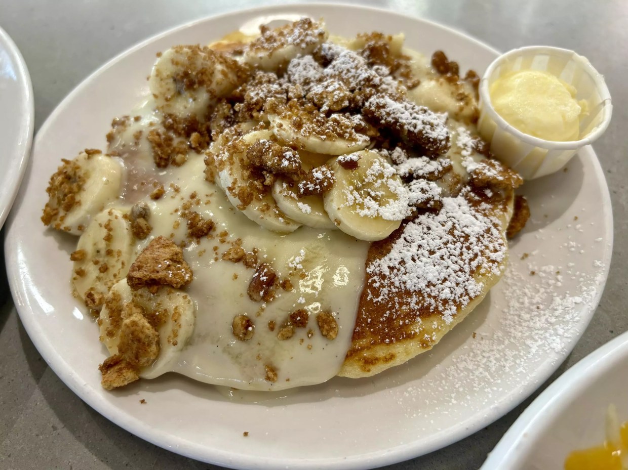 Plate of pancakes with bananas.