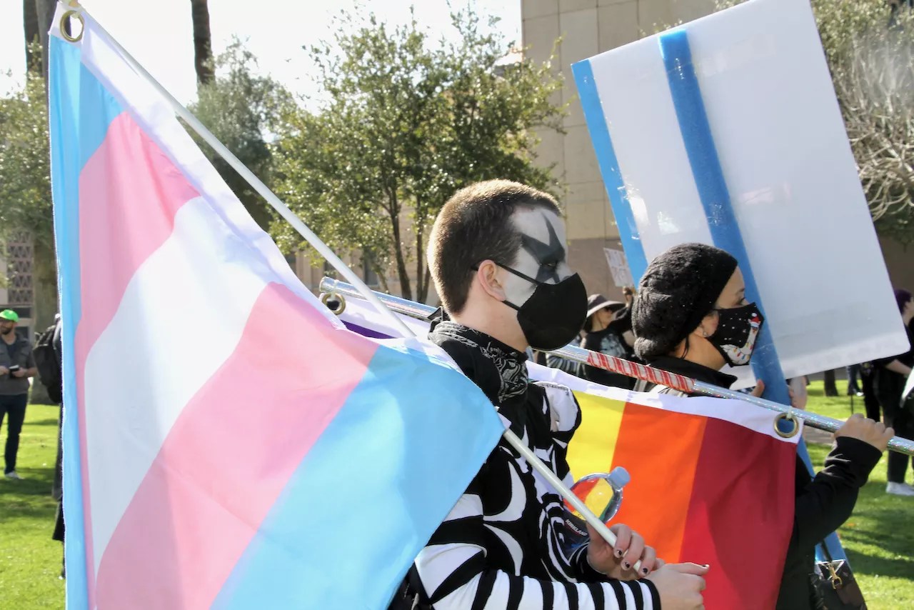 Person holding a trans pride flag