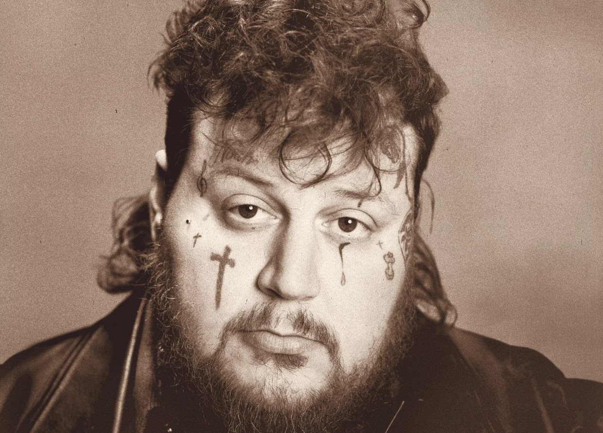 A young man with face tattoos.