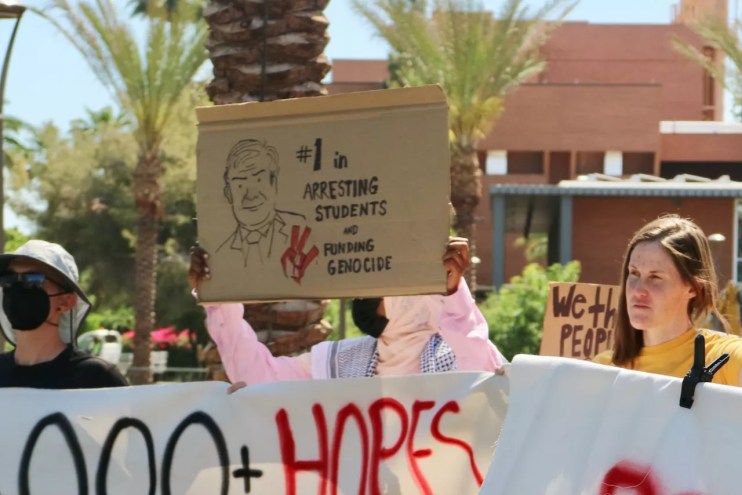 People holding signs at a protest.