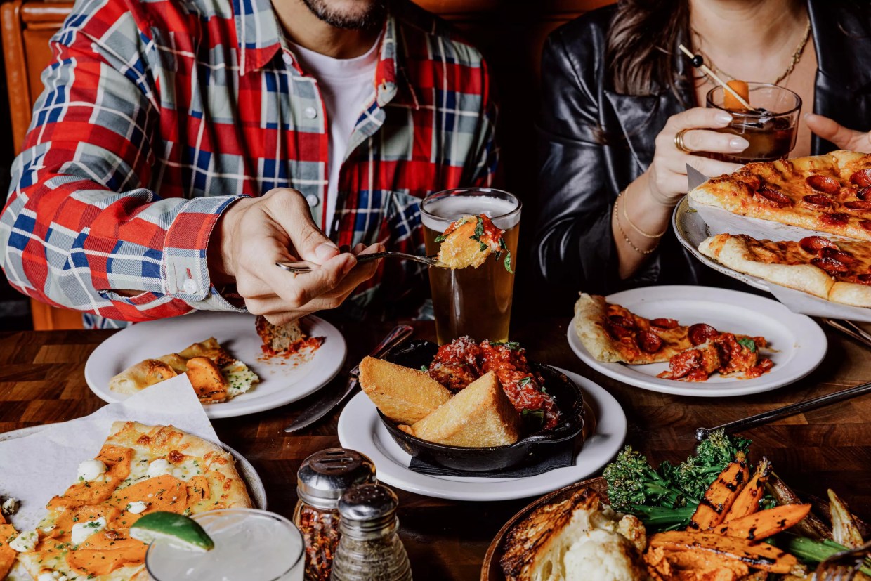 Digging in at a table full of food.