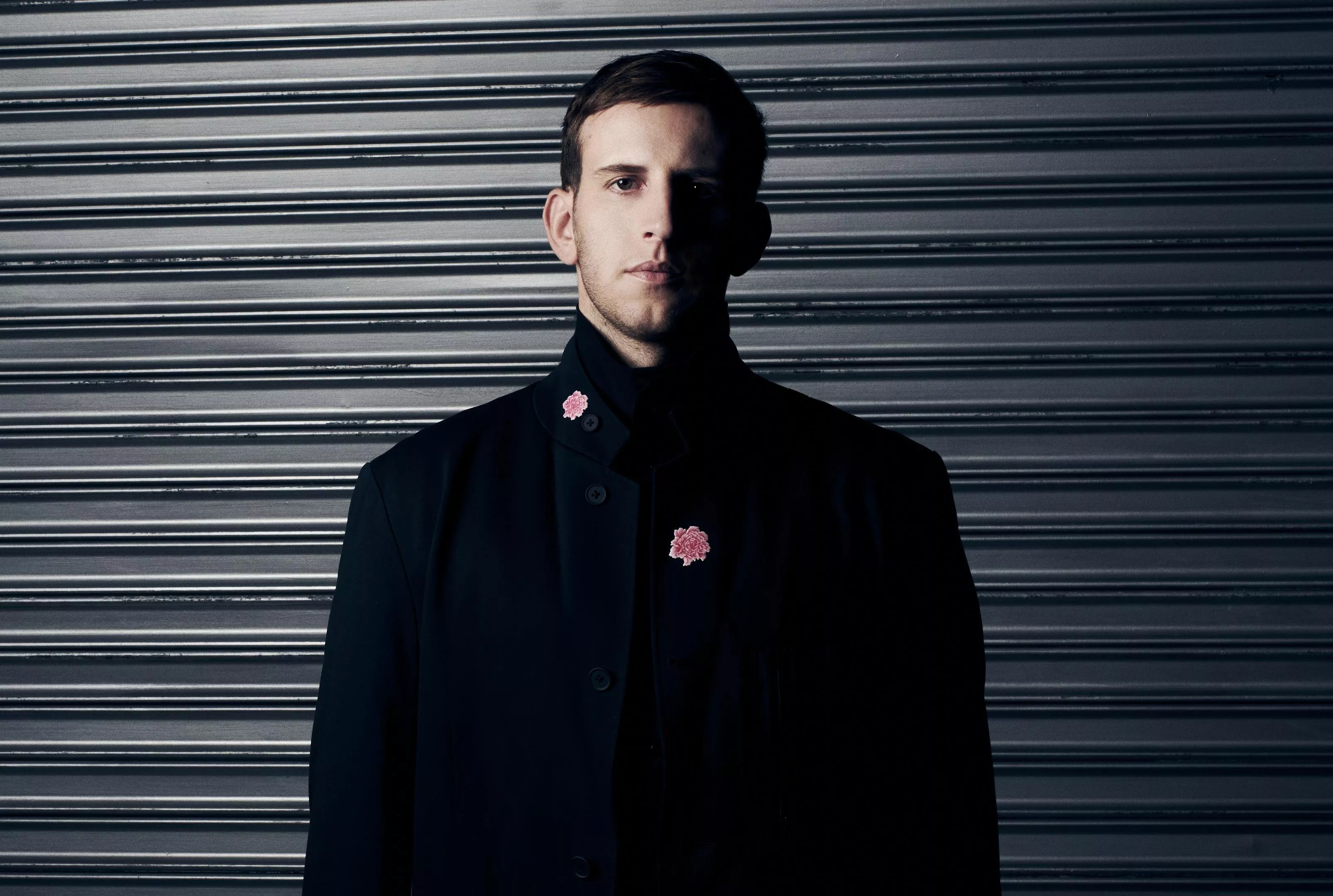 A man standing in front of a wall.