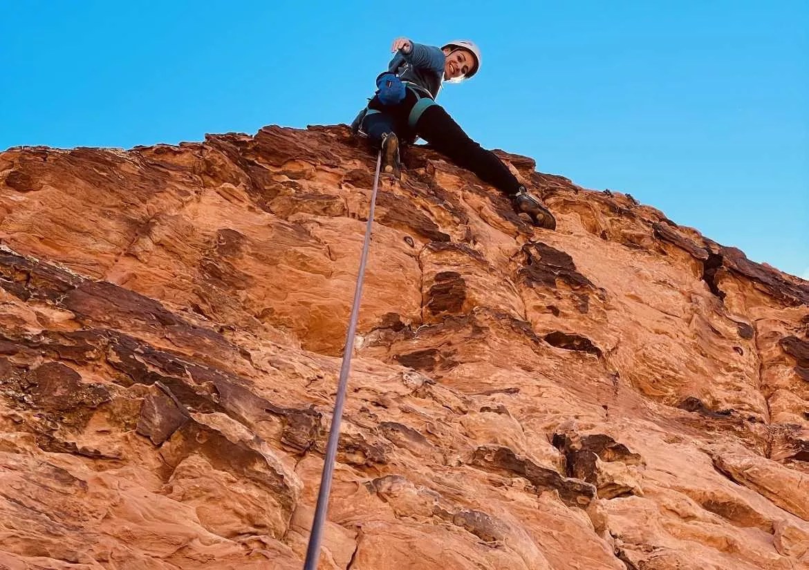 A woman rock-climbing.