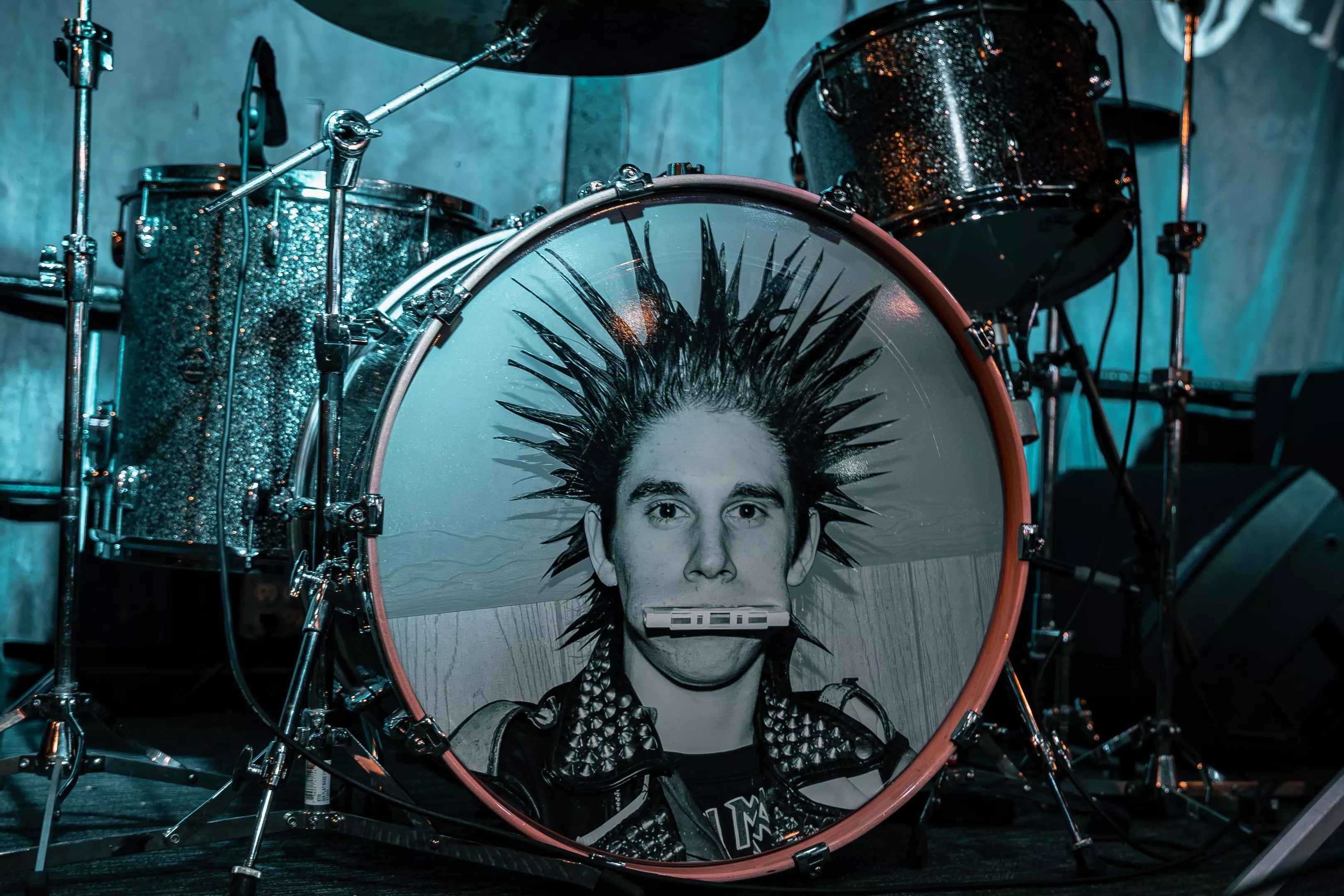A drum kit with a man's face on the bass drum.