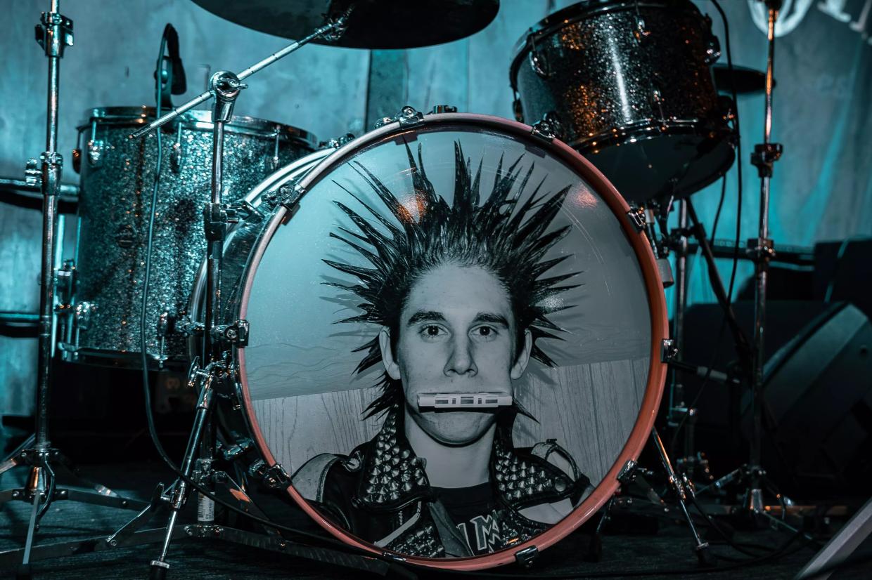 A drum kit with a man's face on the bass drum.