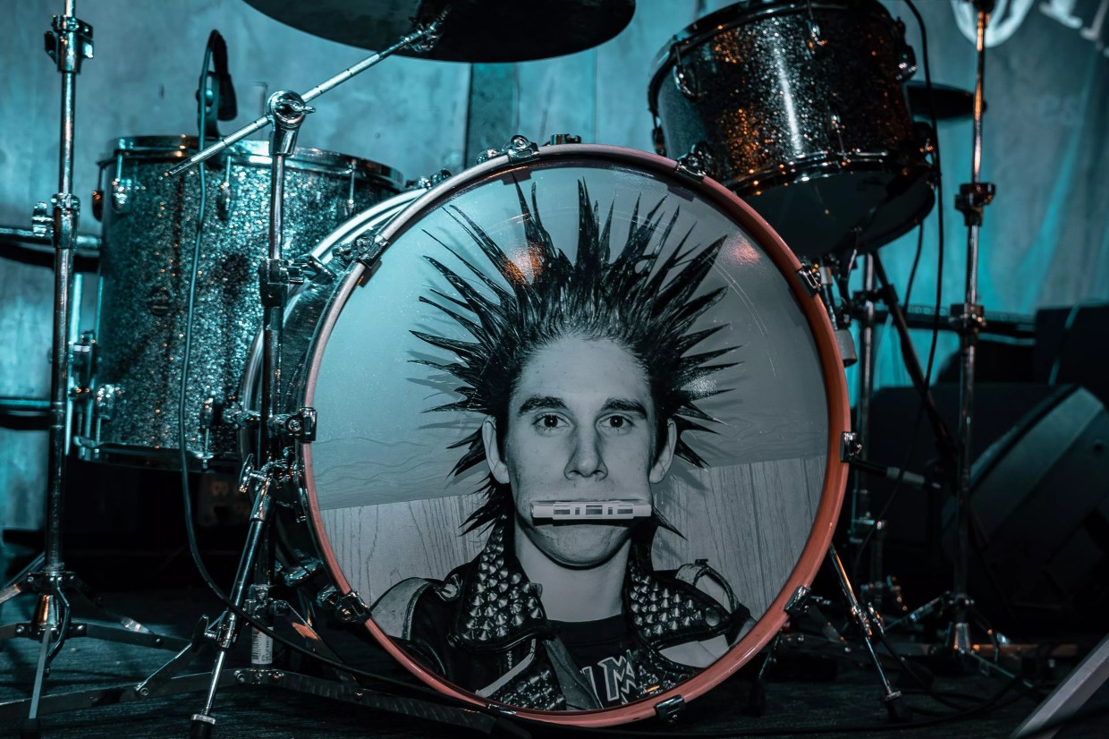 A drum kit with a man's face on the bass drum.