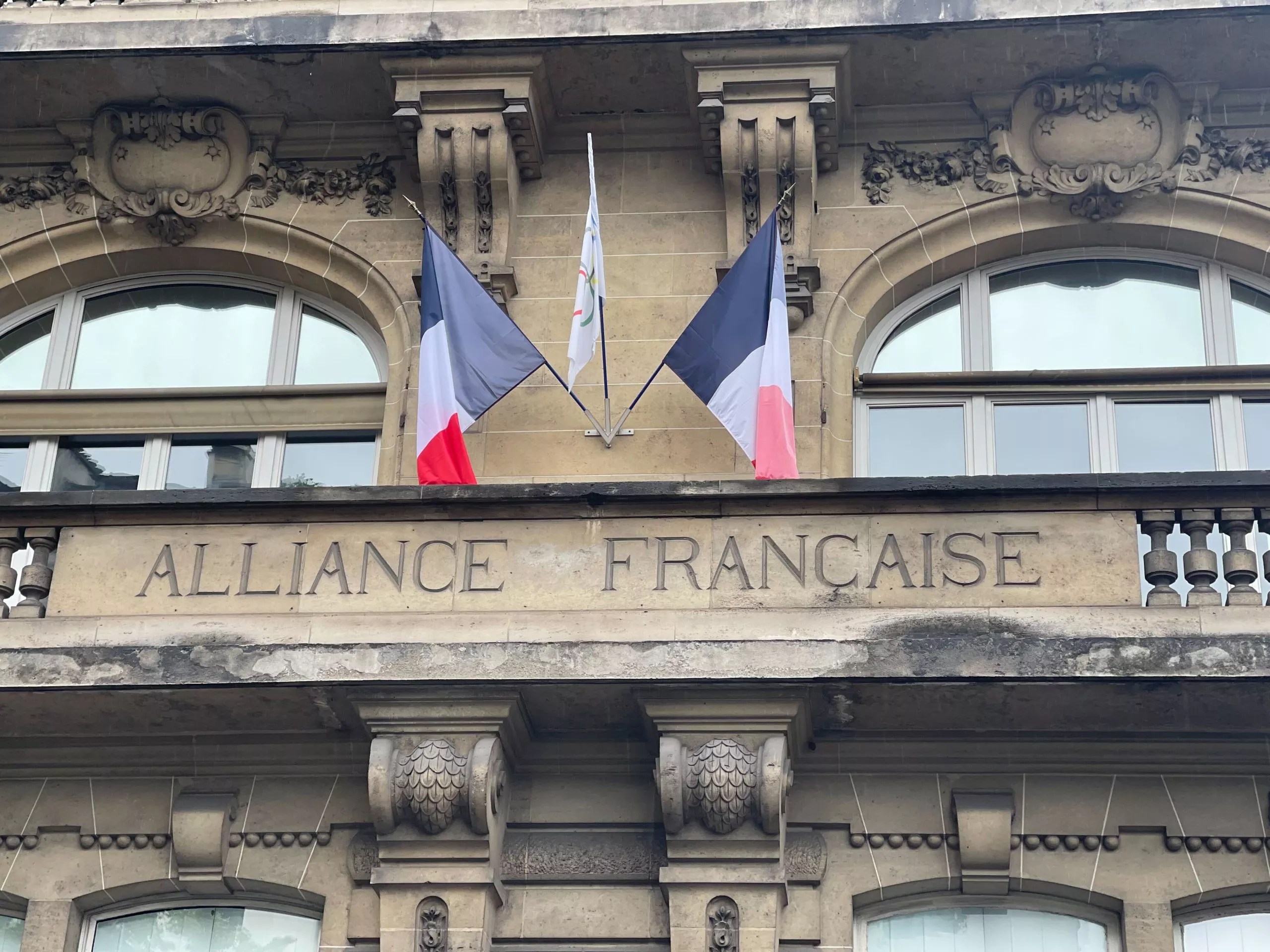 A building in France with a French flag flying on it.