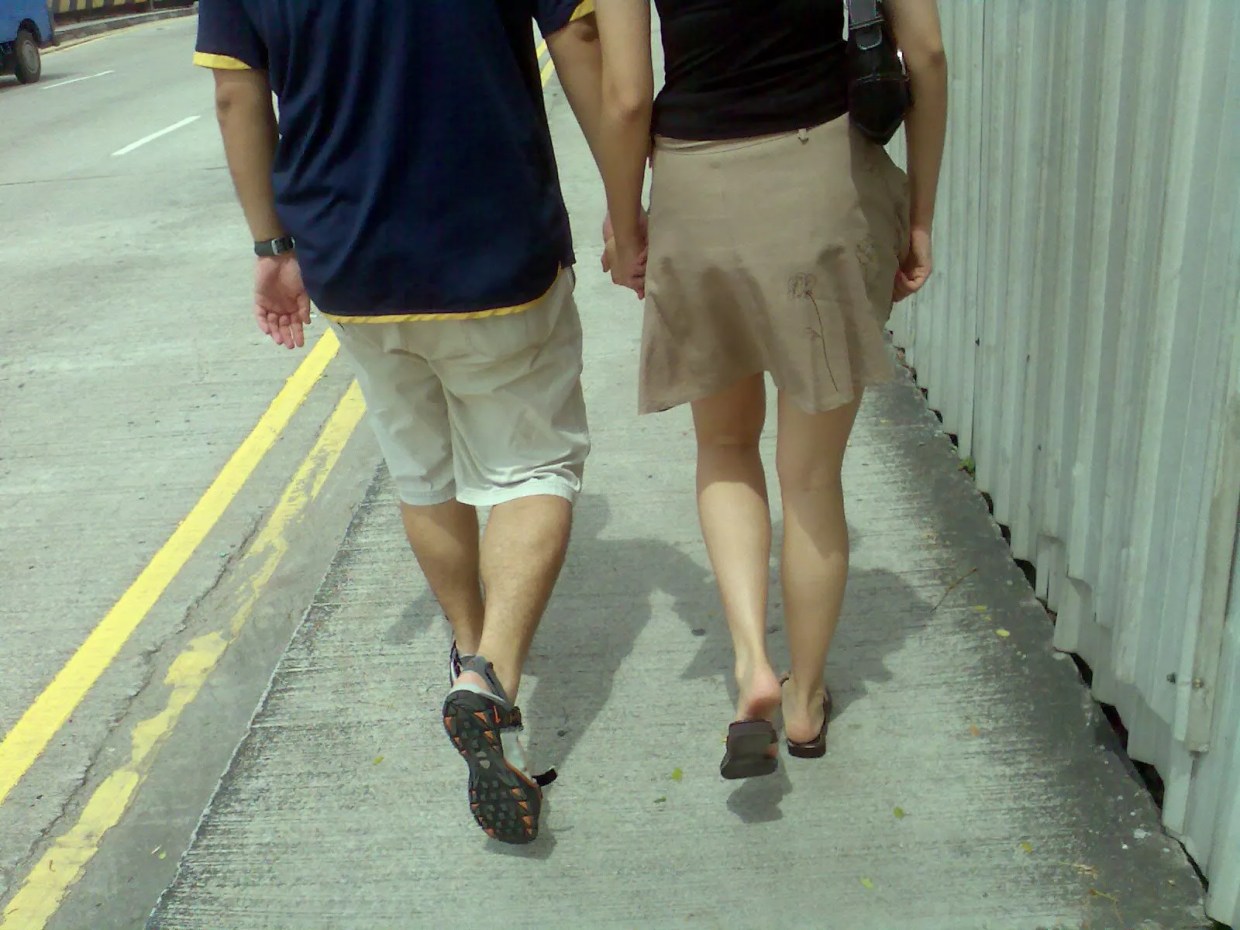 A couple walking down a street.
