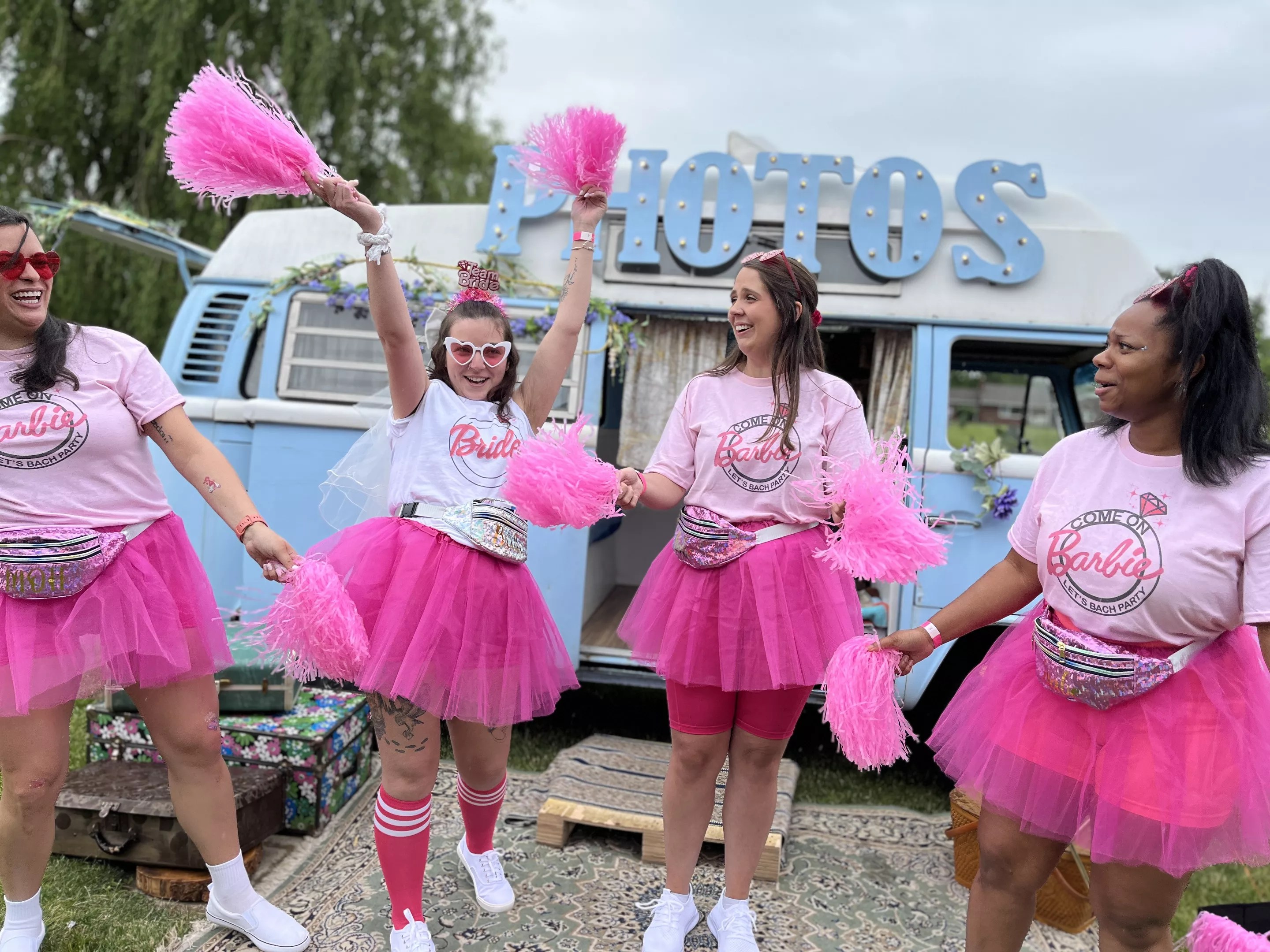 Women dressed in pink shirts and tutus.