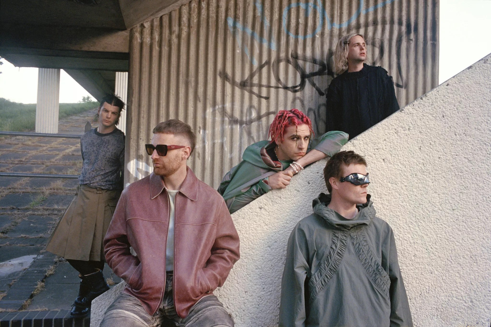 A rock band posing on a staircase.