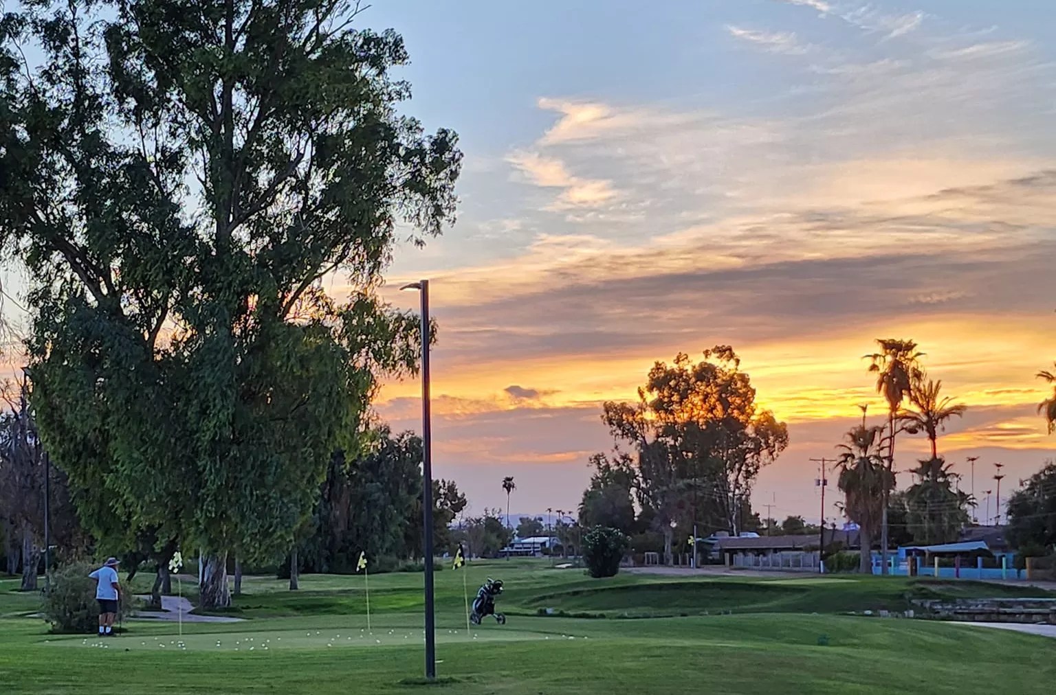 a golf course at sunset