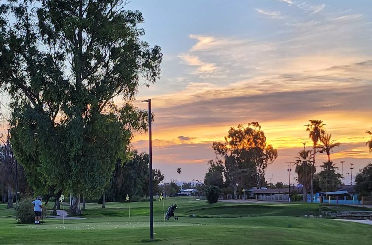 a golf course at sunset