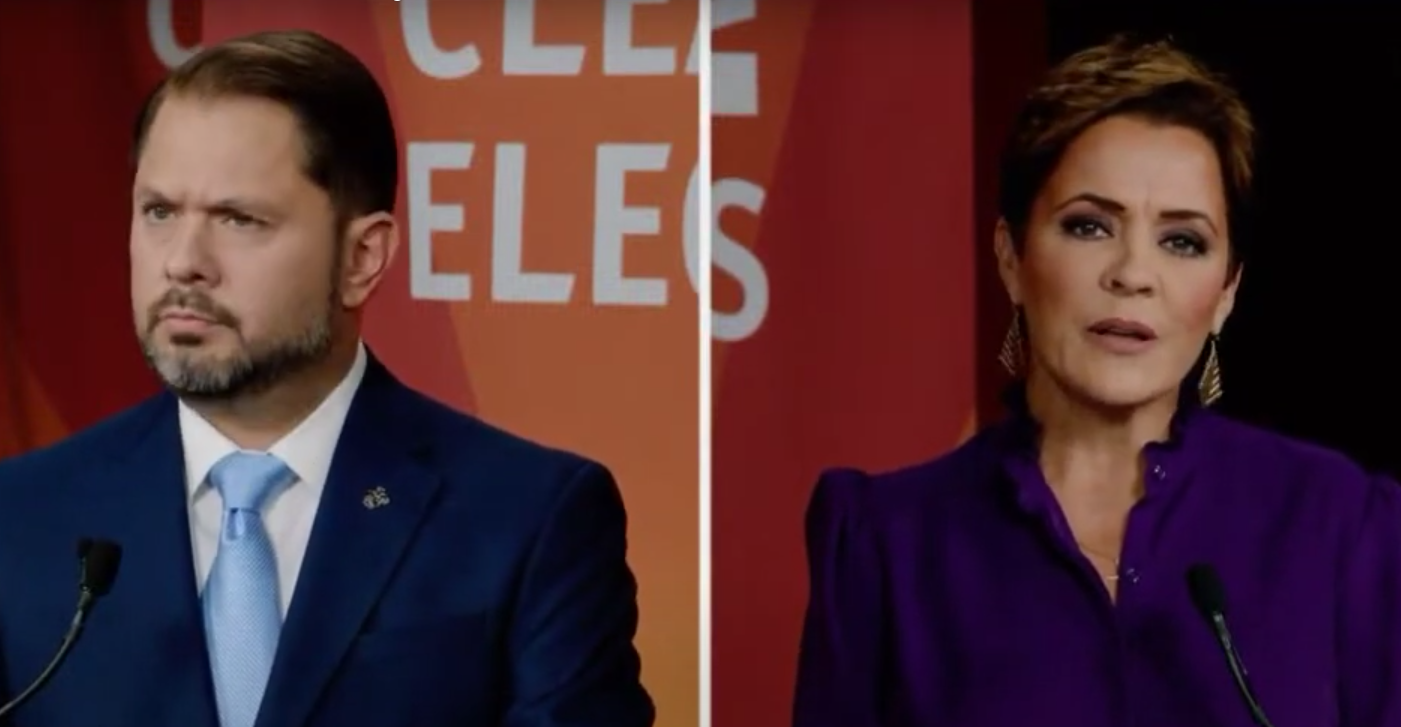 ruben gallego wears an incredulous facial expression while kari lake speaks to a camera