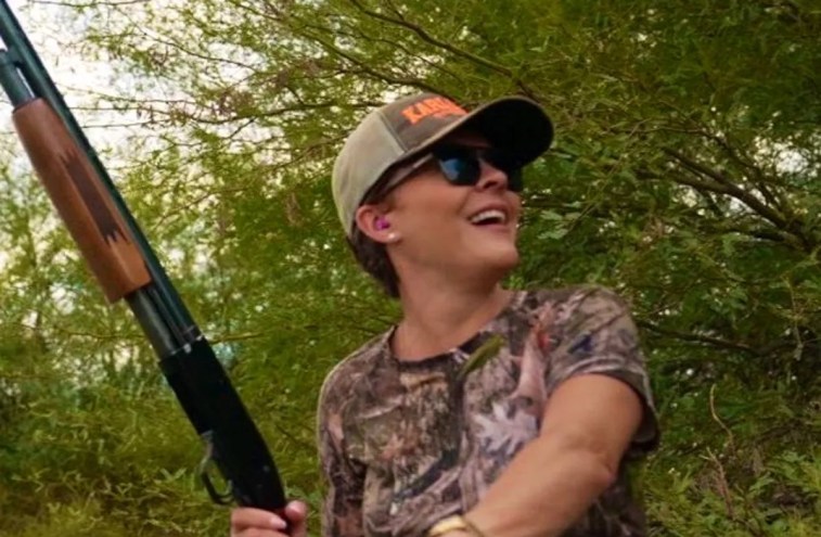 kari lake holding a shotgun while wearing camouflage