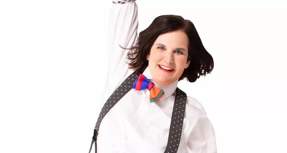 A women in a bow tie and suspenders.