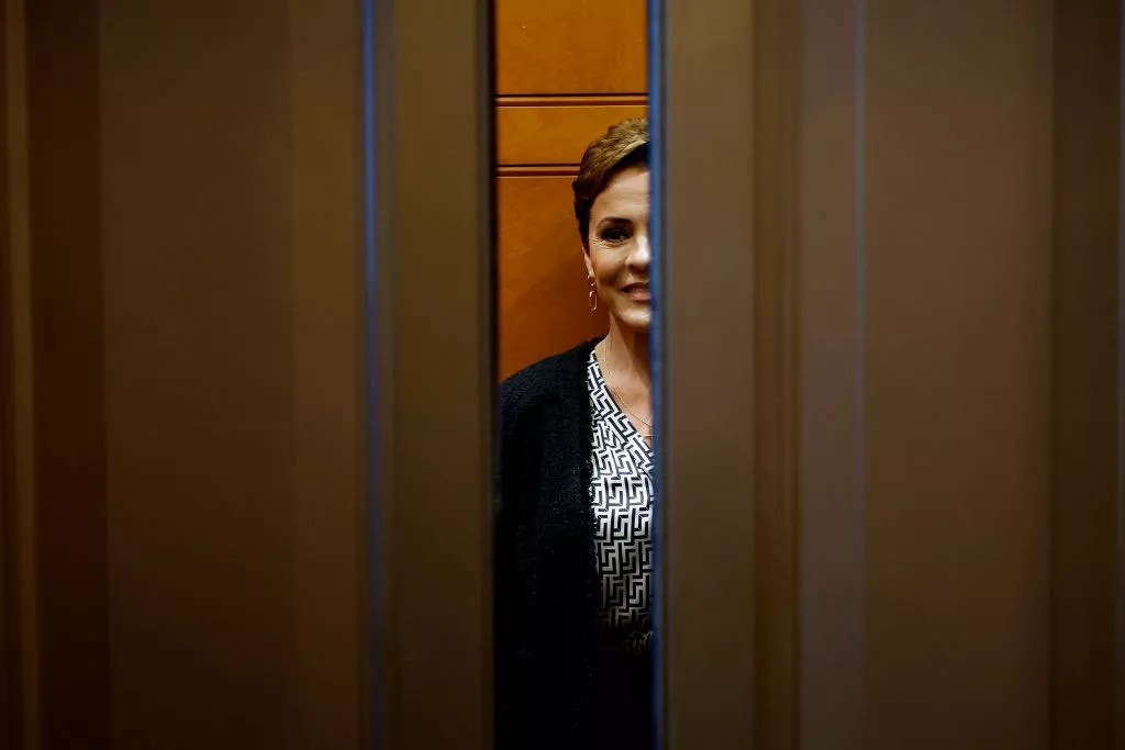 elevator doors close on a smiling kari lake