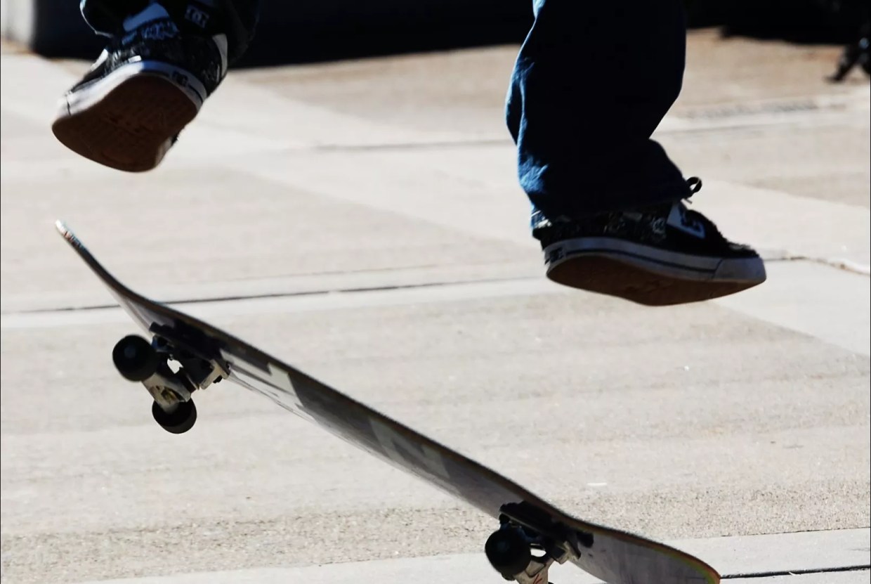 A person on a skateboard in mid-air.