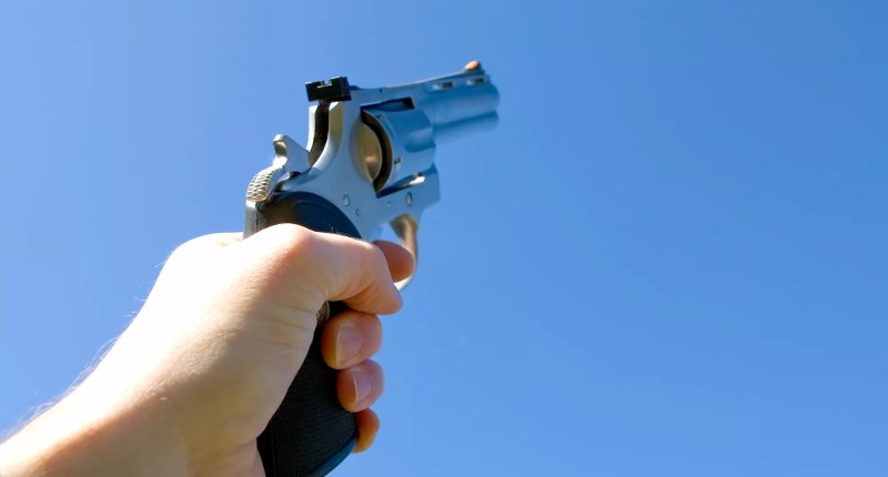 a handgun pointed at the sky