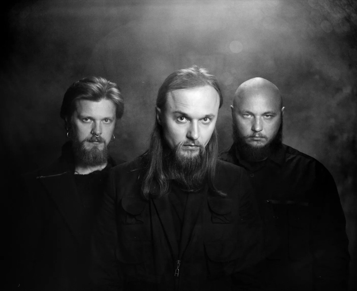 A black and white photo of three men.