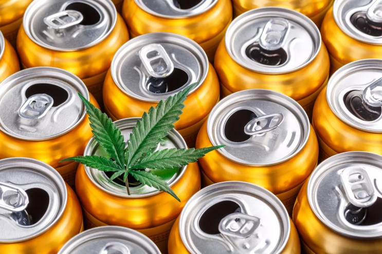 open soda cans with a marijuana leaf on top