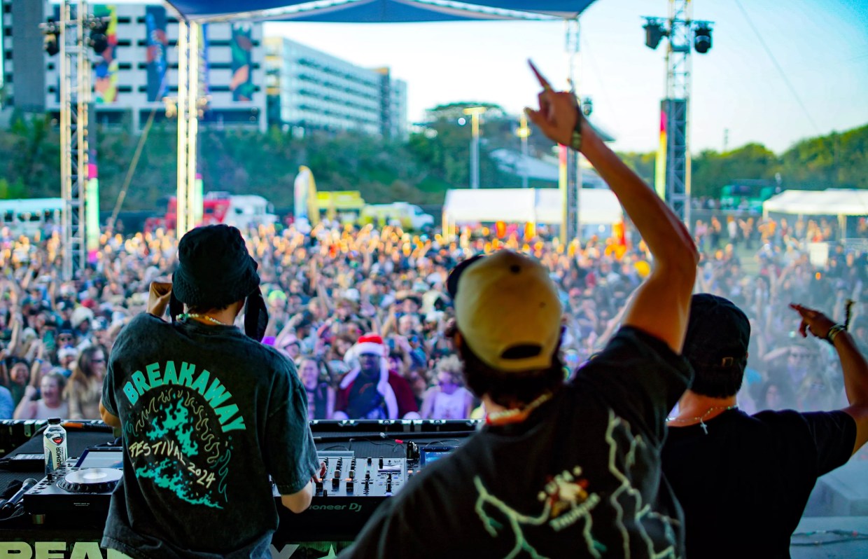 Two men perform in front of a crowd
