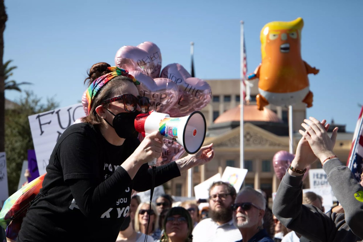 a protester yells into a megaphone