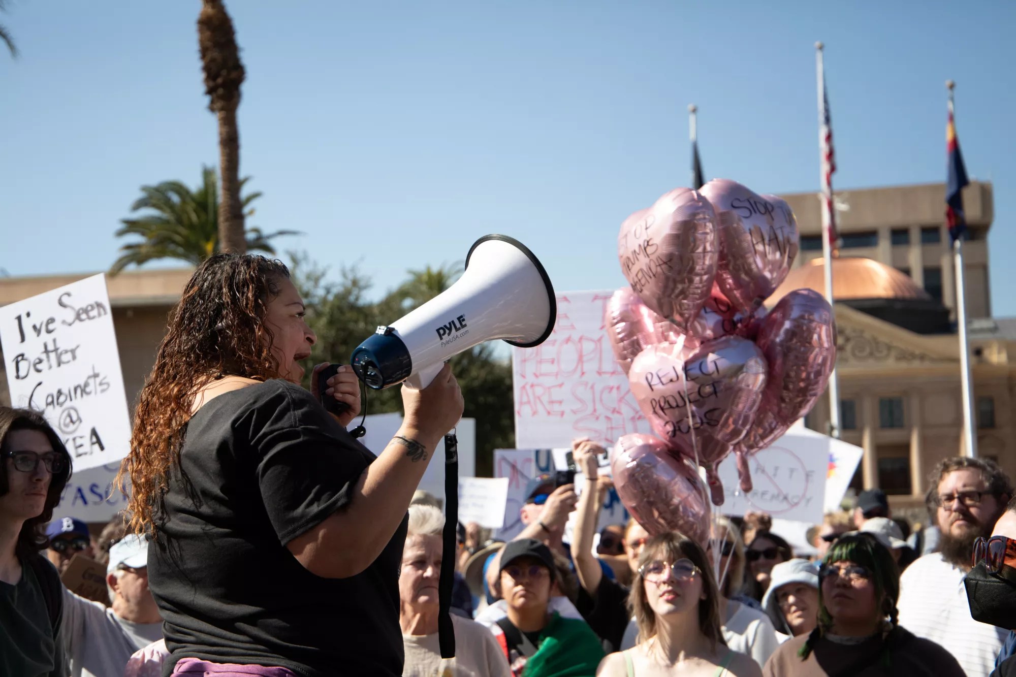 a person speaks into a megaphone at a protest