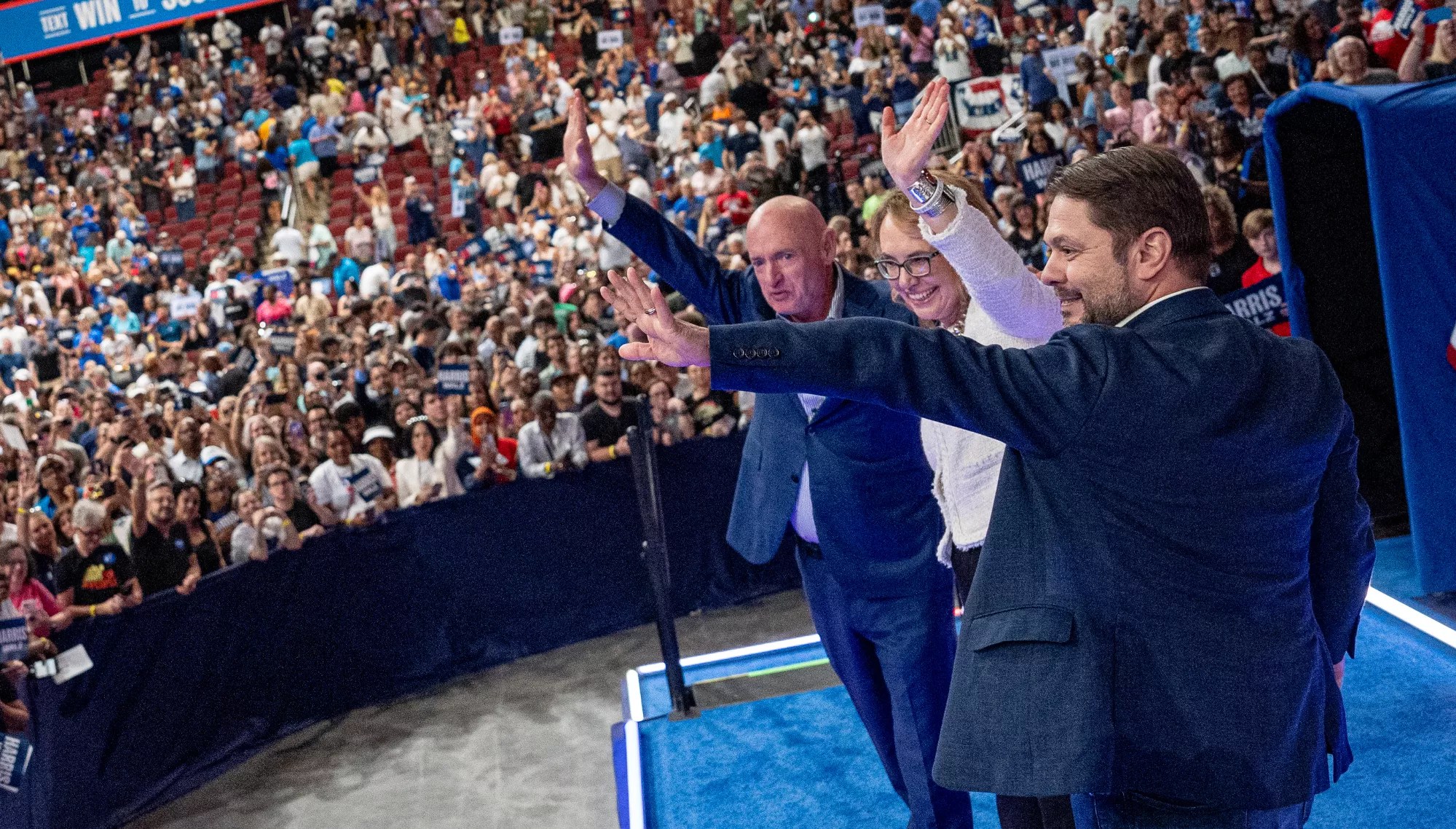 mark kelly, gabby giffords and ruben gallego wave to a crowd