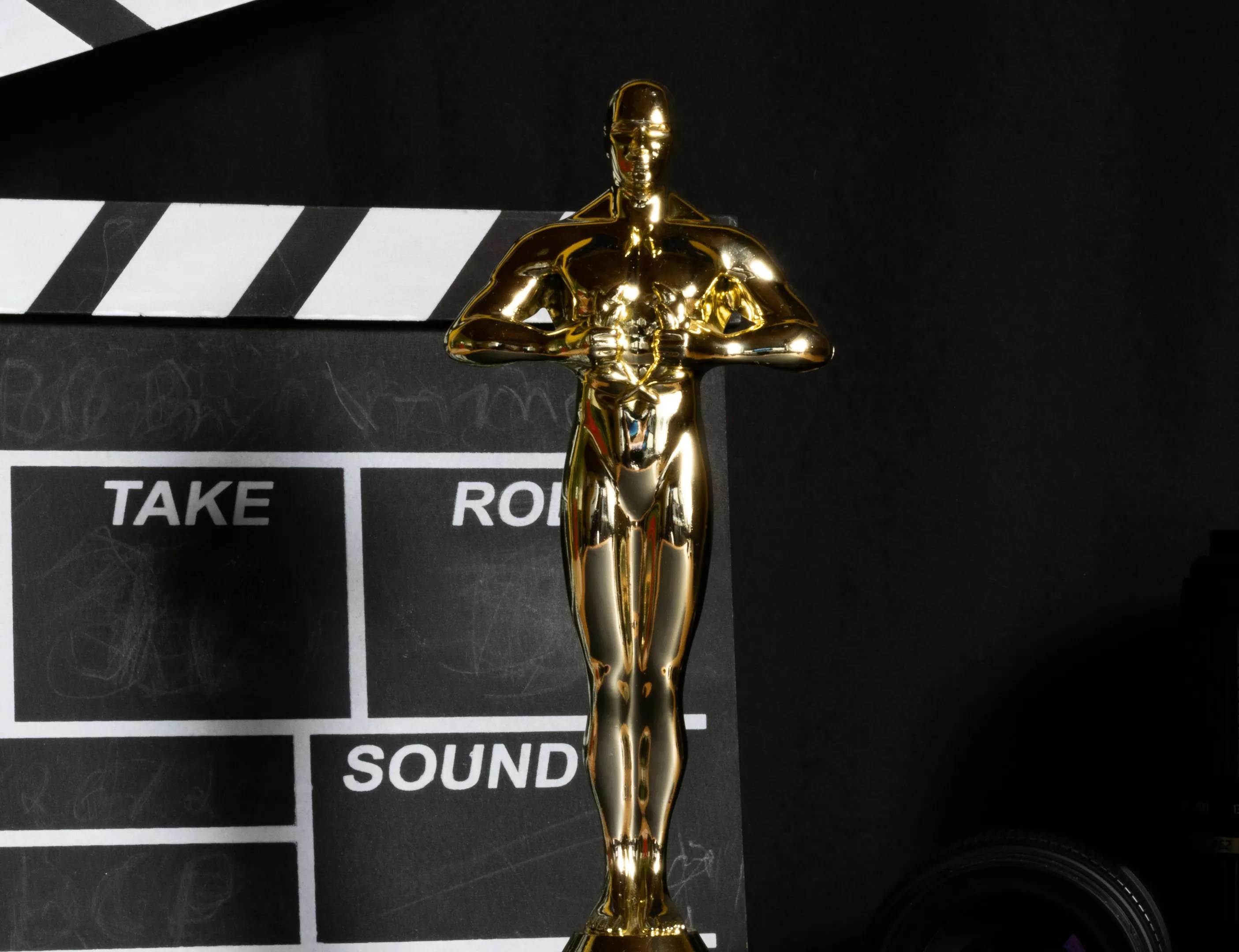 An Academy Award in front of a film slate.