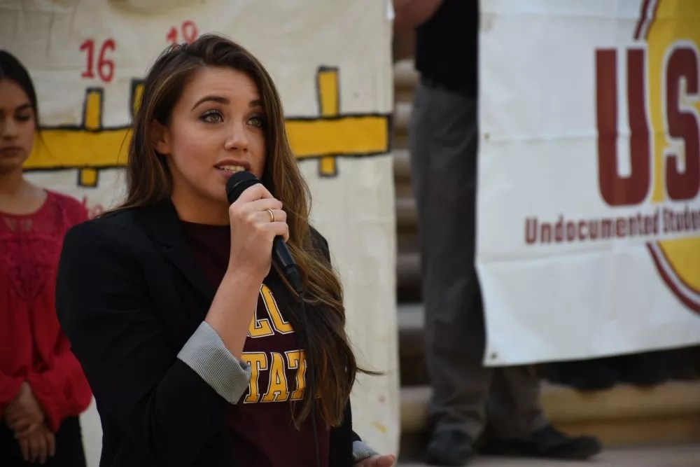 a woman speaks into a microphone